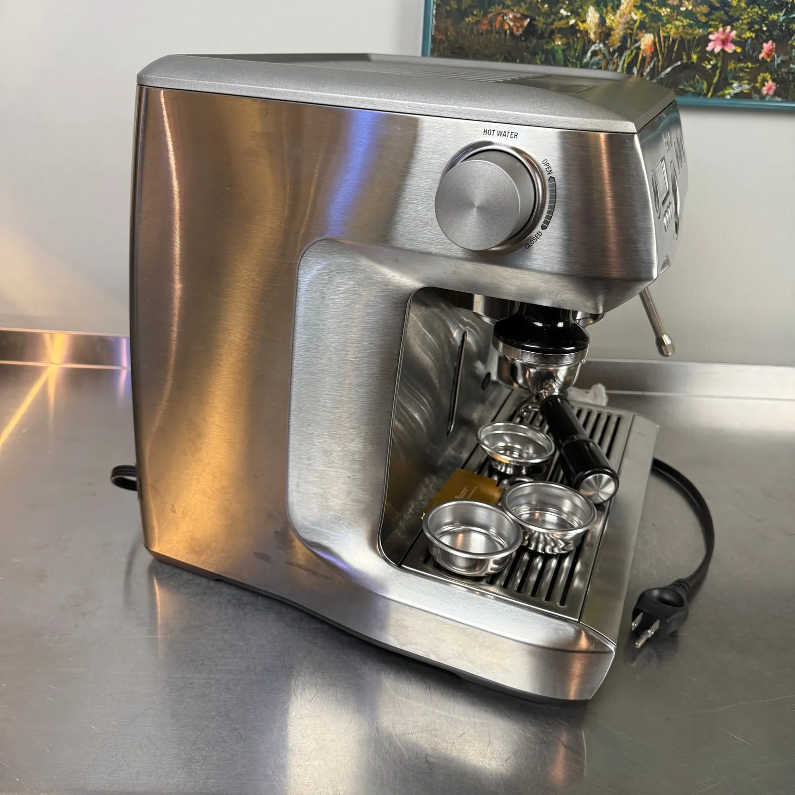 Breville Dual Boiler BES920XL from the front right, filter baskets on the drip tray